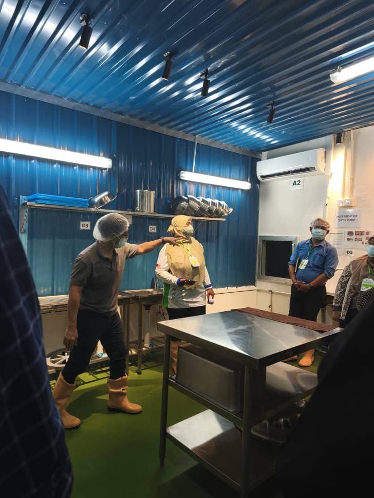 ASEAN delegates observing a demonstration inside a farm processing area